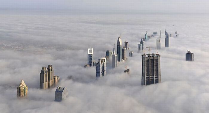 bird's-eye view of buildings above the clouds