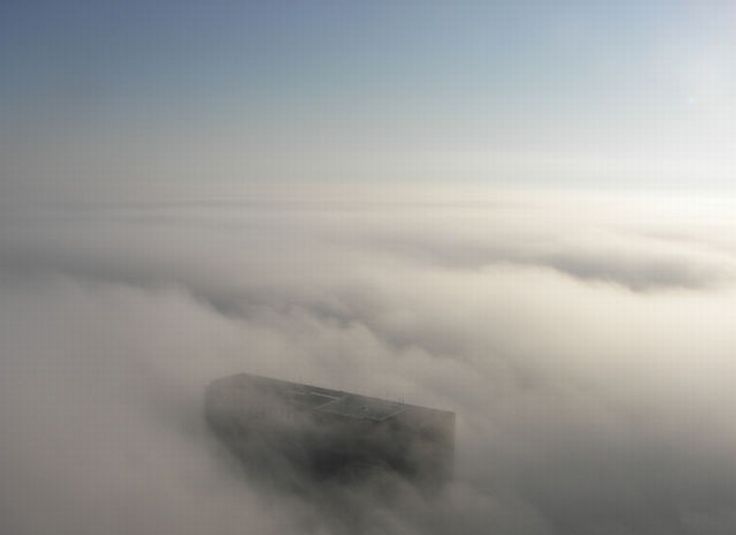 bird's-eye view of buildings above the clouds