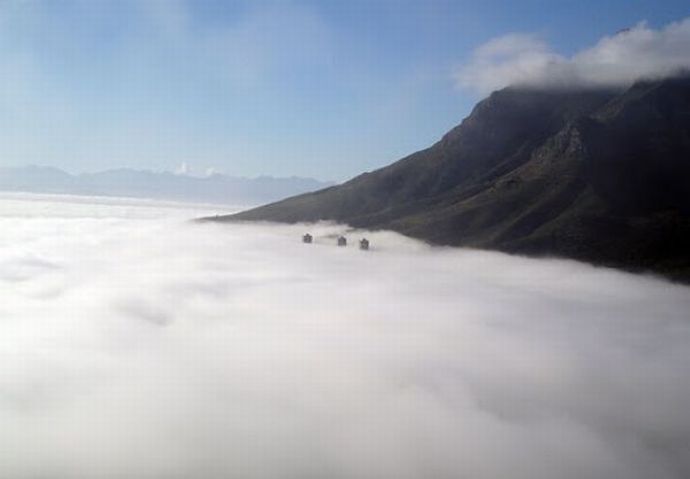 bird's-eye view of buildings above the clouds