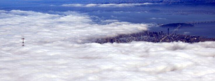 bird's-eye view of buildings above the clouds