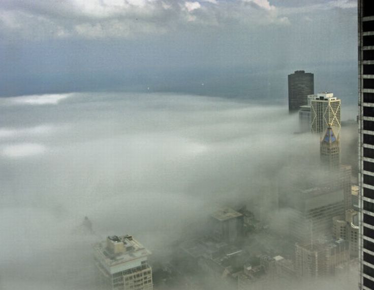 bird's-eye view of buildings above the clouds