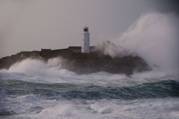 lighthouse in waves