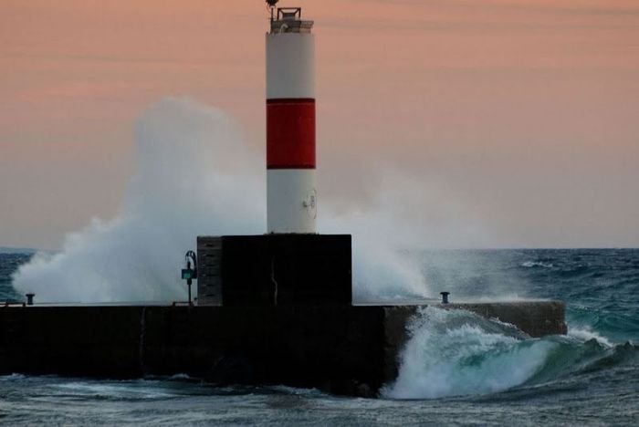 lighthouse in waves